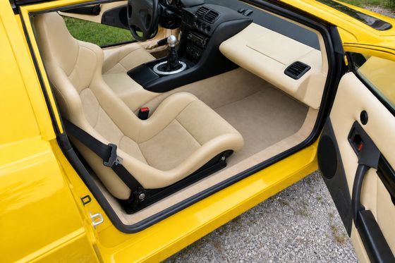 AI-generated preview of a beige 2000 Lotus Esprit V8 interior with Cobra Nogaro Street seats