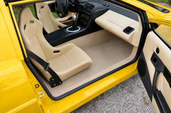AI-generated preview of a beige 2000 Lotus Esprit V8 interior with SJ Sport 300 seats