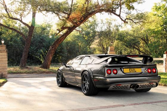 AI-generated preview of a dark grey 2000 Lotus Esprit V8, rear left view, on Splux SD-02 wheels