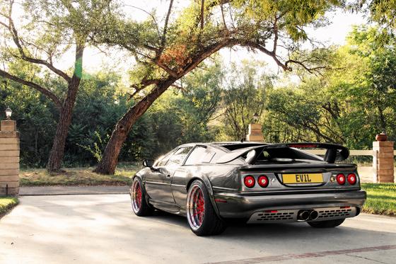 AI-generated preview of a dark grey 2000 Lotus Esprit V8, rear left view, on Splux SD-10 wheels