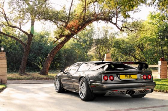 AI-generated preview of a dark grey 2000 Lotus Esprit V8, rear left view, on Splux SD-18 wheels