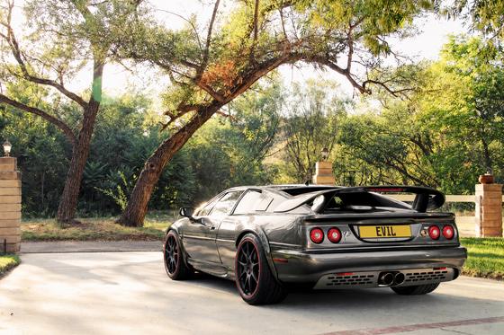 AI-generated preview of a dark grey 2000 Lotus Esprit V8, rear left view, on Splux SL-01 wheels