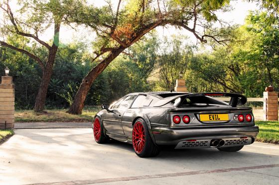 AI-generated preview of a dark grey 2000 Lotus Esprit V8, rear left view, on Splux SL-C03 wheels