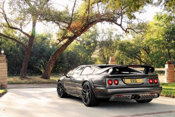 AI-generated preview of a dark grey 2000 Lotus Esprit V8, rear left view, on Splux SL-C15 wheels