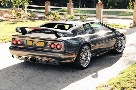 AI-generated preview of a dark grey 2000 Lotus Esprit V8, rear right view, on Splux SA-04 wheels