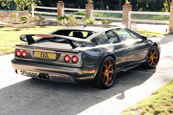 AI-generated preview of a dark grey 2000 Lotus Esprit V8, rear right view, on Splux SA-05 wheels