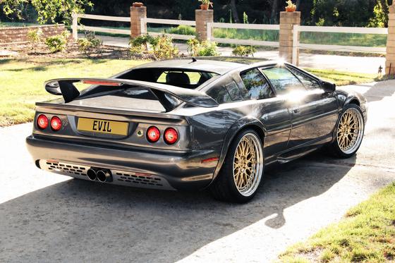 AI-generated preview of a dark grey 2000 Lotus Esprit V8, rear right view, on Splux SD-01S wheels