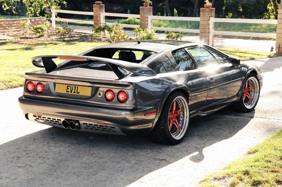 AI-generated preview of a dark grey 2000 Lotus Esprit V8, rear right view, on Splux SD-10 wheels