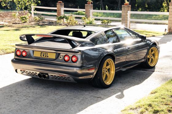 AI-generated preview of a dark grey 2000 Lotus Esprit V8, rear right view, on Splux SD-11 wheels