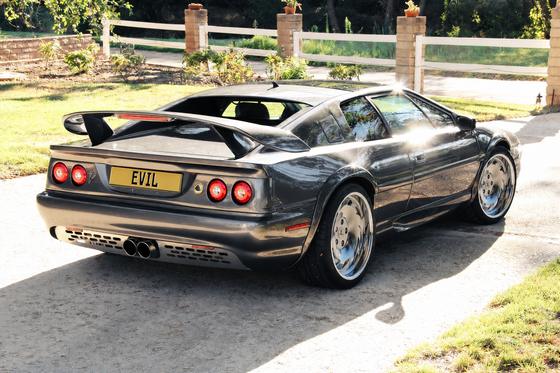 AI-generated preview of a dark grey 2000 Lotus Esprit V8, rear right view, on Splux SD-18 wheels