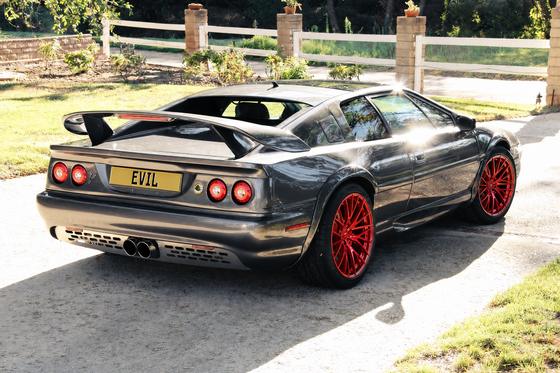 AI-generated preview of a dark grey 2000 Lotus Esprit V8, rear right view, on Splux SL-C03 wheels